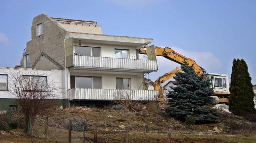 What is the interpretation of a dream about demolishing a house for a married woman?